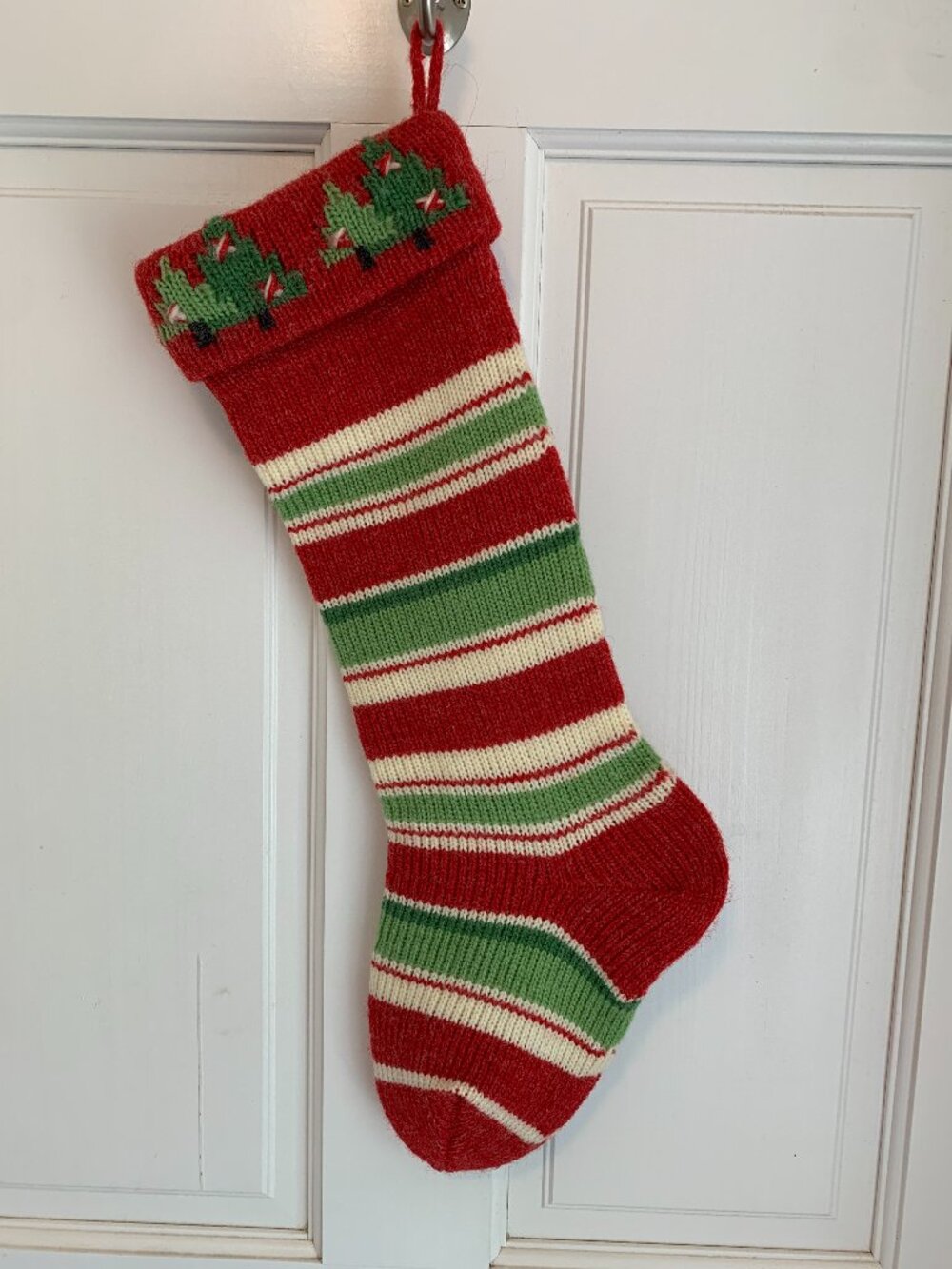 Vintage style knit Christmas stocking in red green and ivory stripe pattern
